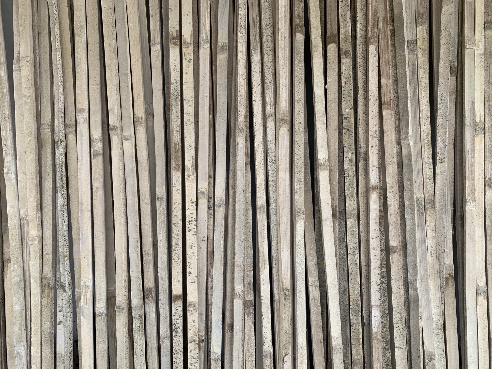 A laminated bamboo board passing through the wide-belt calibrating sander
